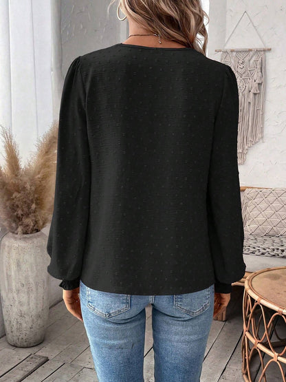 Black - Women's dusty rose long-sleeve blouse featuring a lace V-neckline, textured Swiss dot fabric, and smocked cuffs, styled with blue jeans.