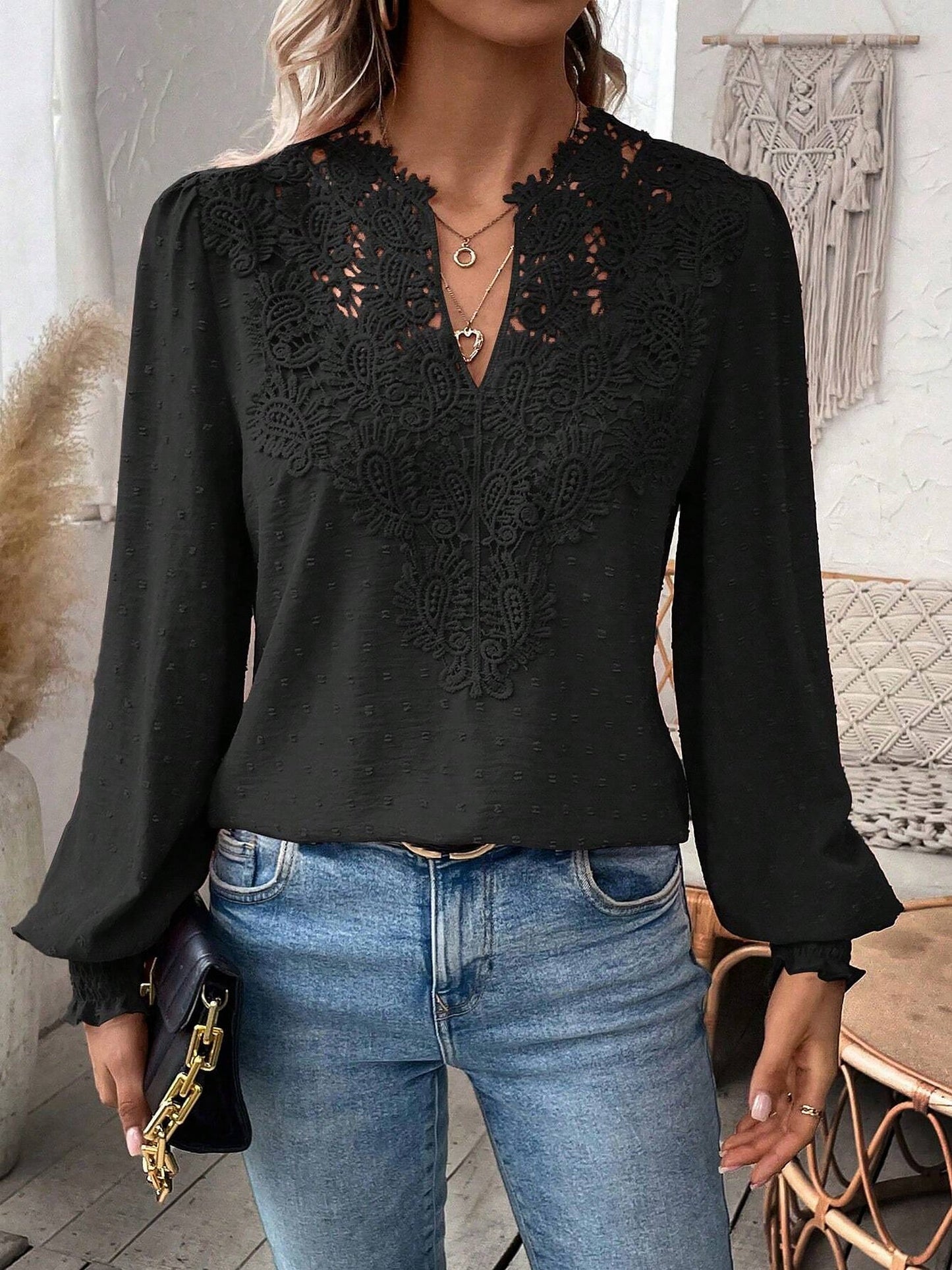 Black - Women's dusty rose long-sleeve blouse featuring a lace V-neckline, textured Swiss dot fabric, and smocked cuffs, styled with blue jeans.