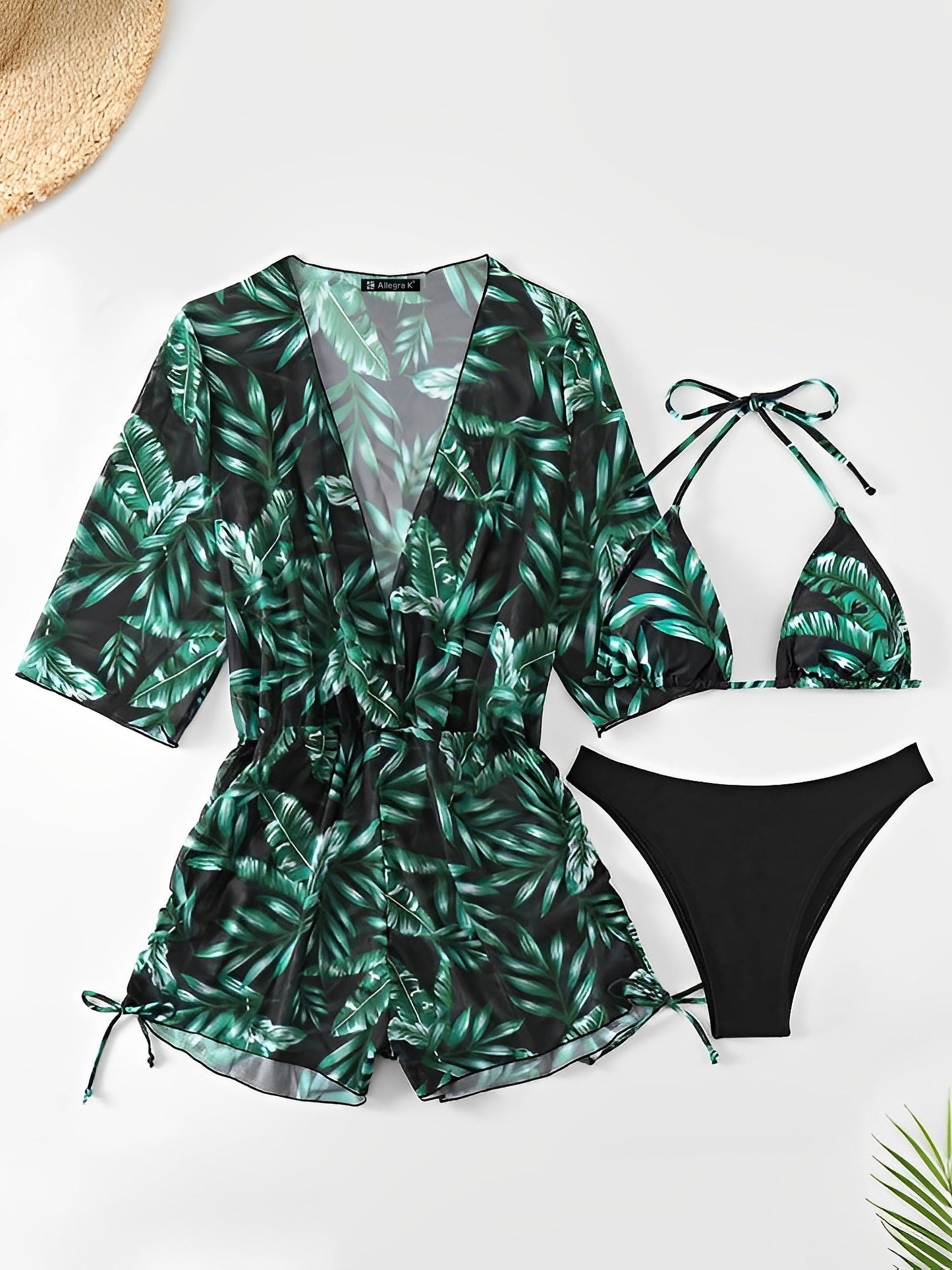 Dark Green - A woman models a sheer, short-sleeve mini cover-up with a vibrant tropical leaf print in shades of purple, blue, and pink, featuring a deep V-neck, drawstring waist, and ruched sides with ties.