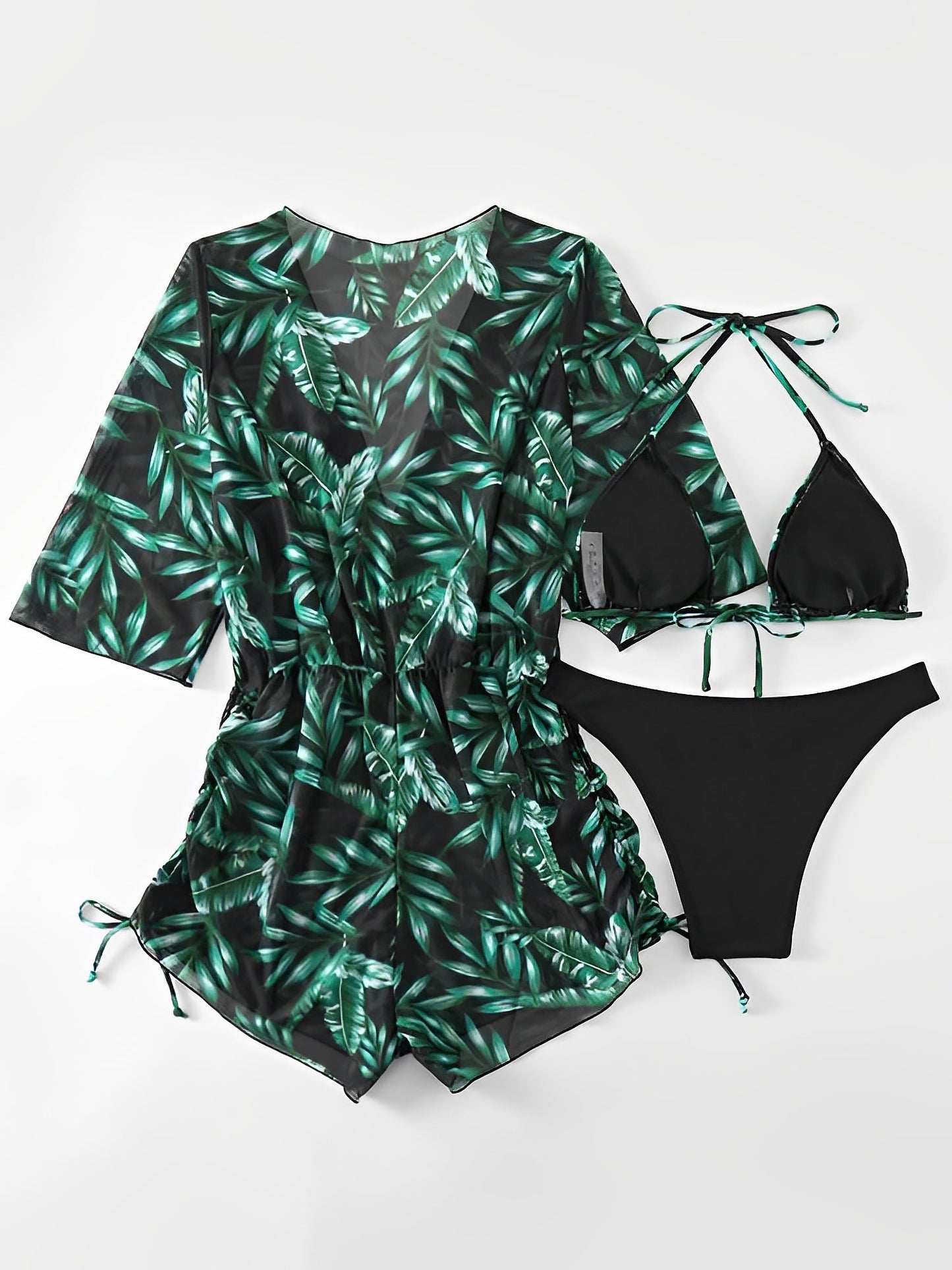 Dark Green - A woman models a sheer, short-sleeve mini cover-up with a vibrant tropical leaf print in shades of purple, blue, and pink, featuring a deep V-neck, drawstring waist, and ruched sides with ties.