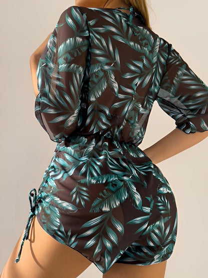 Dark Green - A woman models a sheer, short-sleeve mini cover-up with a vibrant tropical leaf print in shades of purple, blue, and pink, featuring a deep V-neck, drawstring waist, and ruched sides with ties.
