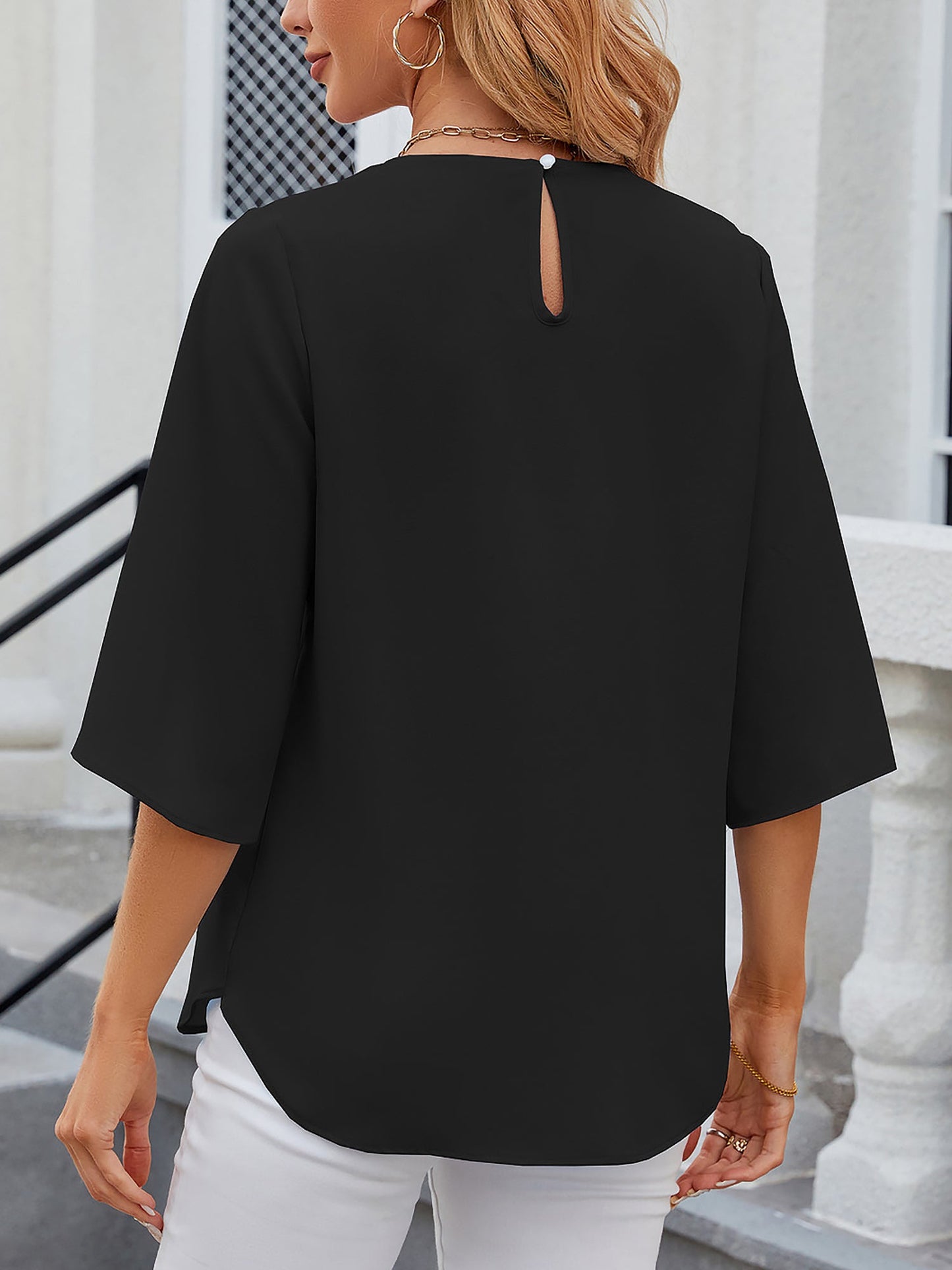 Black - Women's light blue relaxed fit blouse featuring a pleated front neckline and short split sleeves, styled with white trousers.