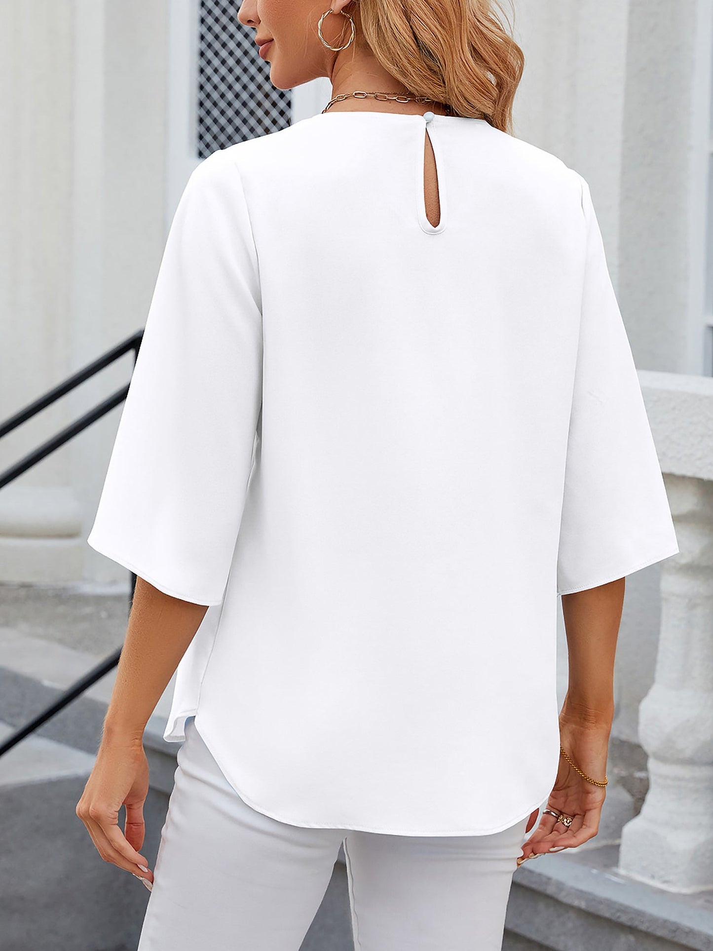 White - Women's light blue relaxed fit blouse featuring a pleated front neckline and short split sleeves, styled with white trousers.