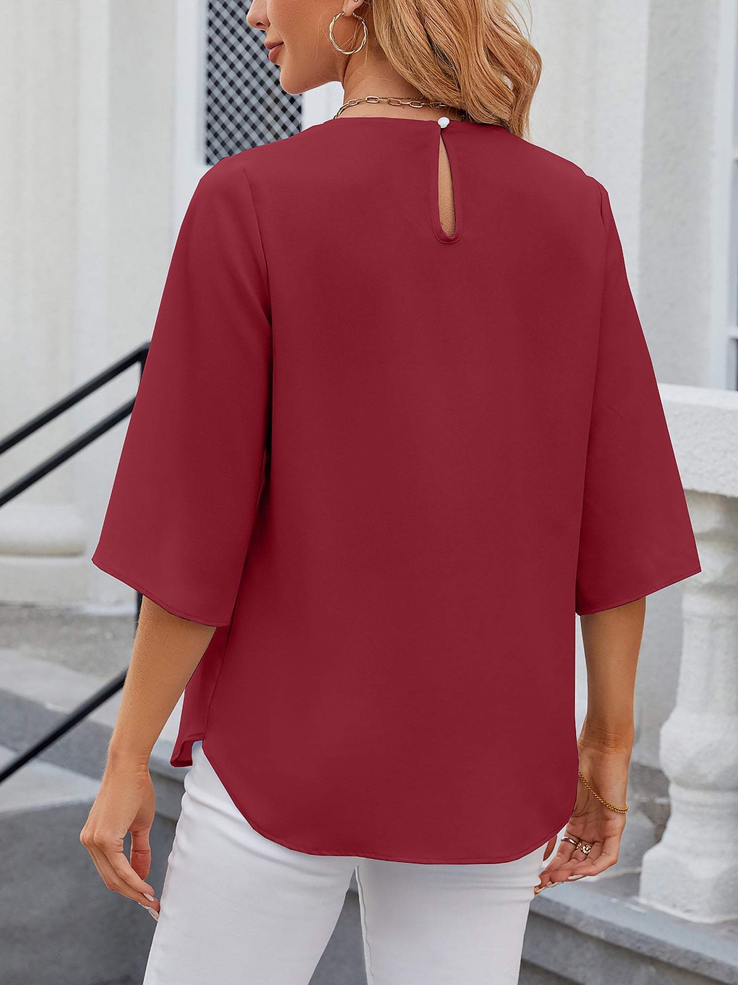 Burgundy - Women's light blue relaxed fit blouse featuring a pleated front neckline and short split sleeves, styled with white trousers.