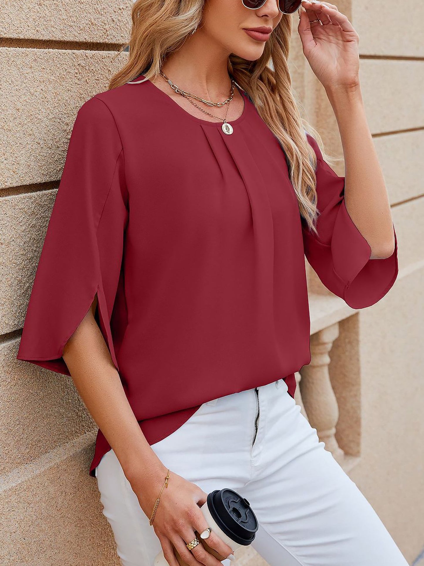 Burgundy - Women's light blue relaxed fit blouse featuring a pleated front neckline and short split sleeves, styled with white trousers.