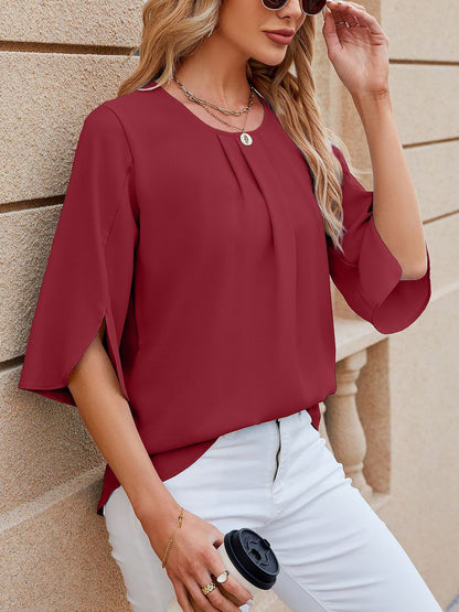 Burgundy - Women's light blue relaxed fit blouse featuring a pleated front neckline and short split sleeves, styled with white trousers.