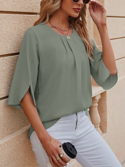 Light Green - Women's light blue relaxed fit blouse featuring a pleated front neckline and short split sleeves, styled with white trousers.