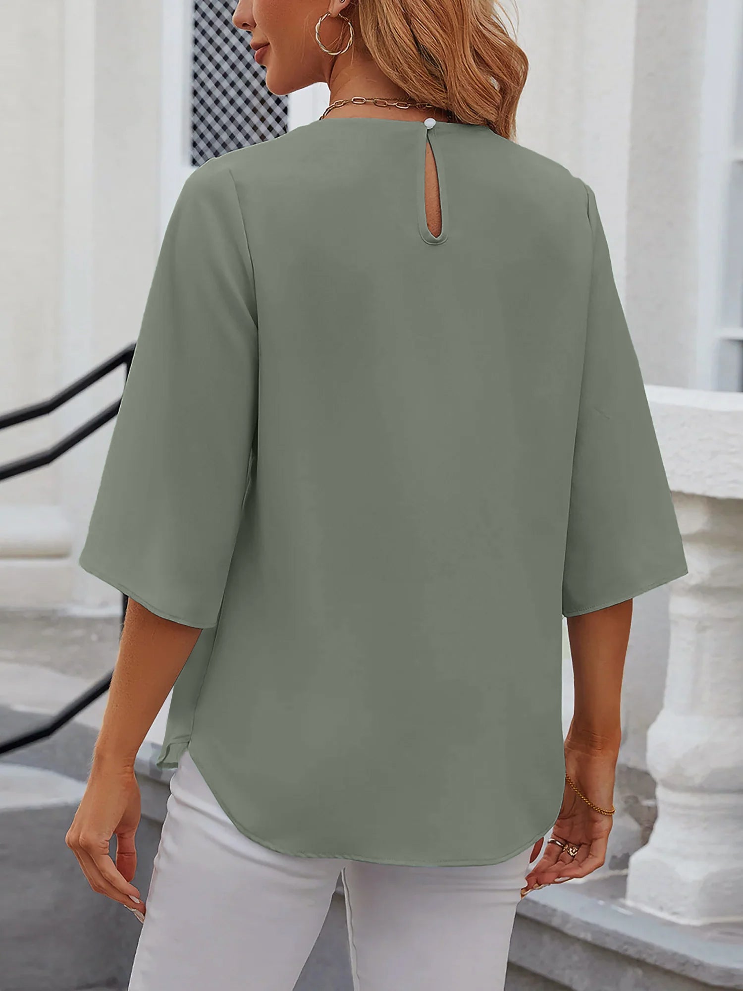 Light Green - Women's light blue relaxed fit blouse featuring a pleated front neckline and short split sleeves, styled with white trousers.