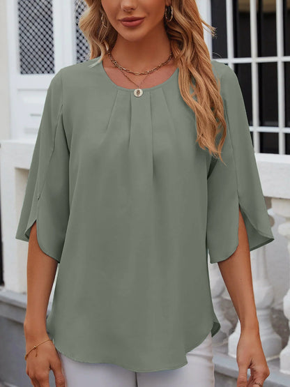 Light Green - Women's light blue relaxed fit blouse featuring a pleated front neckline and short split sleeves, styled with white trousers.