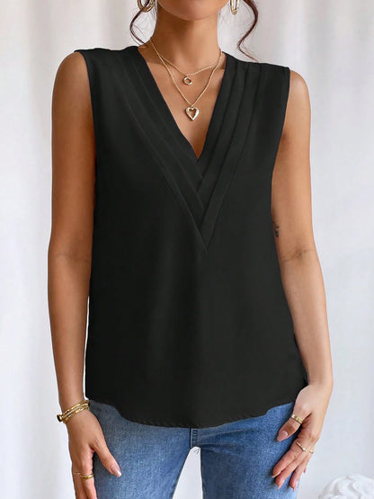 Black - Women's solid white sleeveless blouse featuring a deep V-neckline with layered pleat detailing, styled with blue jeans and a black belt.