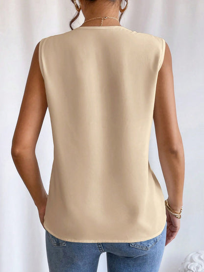 Apricot - Women's solid white sleeveless blouse featuring a deep V-neckline with layered pleat detailing, styled with blue jeans and a black belt.