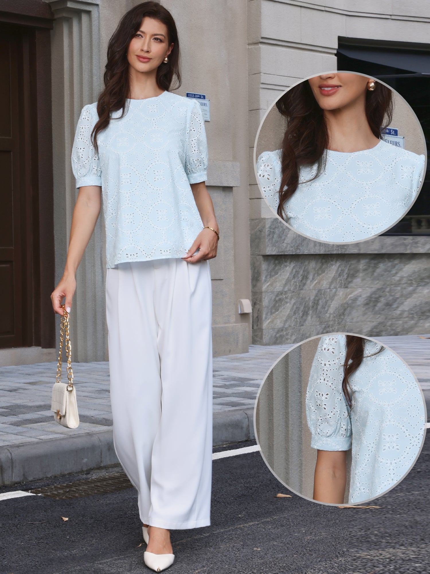 Light Blue - A woman models a light blue, short-sleeve eyelet blouse with a round neckline, paired with white wide-leg trousers.