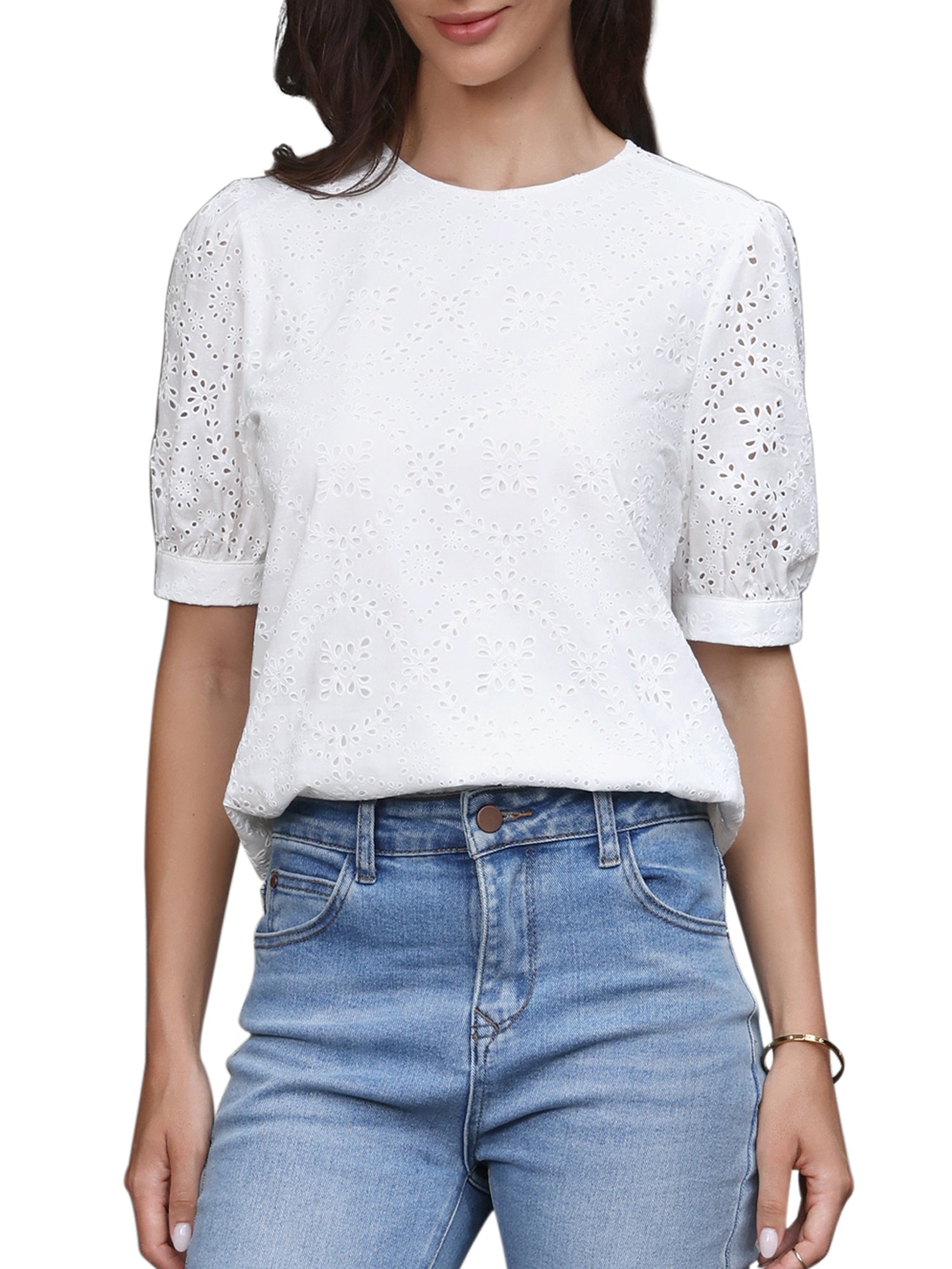 White - A woman models a light blue, short-sleeve eyelet blouse with a round neckline, paired with white wide-leg trousers.
