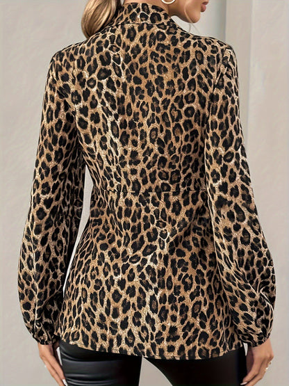 Brown - A woman wearing a long-sleeved, collared, tie-front blouse in a brown and black leopard print, paired with black pants.