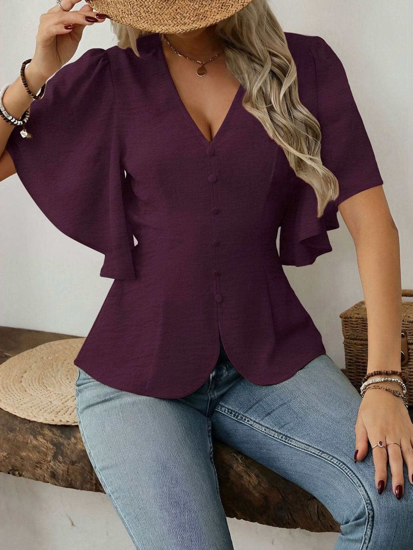 Dark Red - Women's rust orange short flutter sleeve blouse featuring a V-neckline, fabric-covered button front, and a tailored peplum waist, styled with blue jeans.