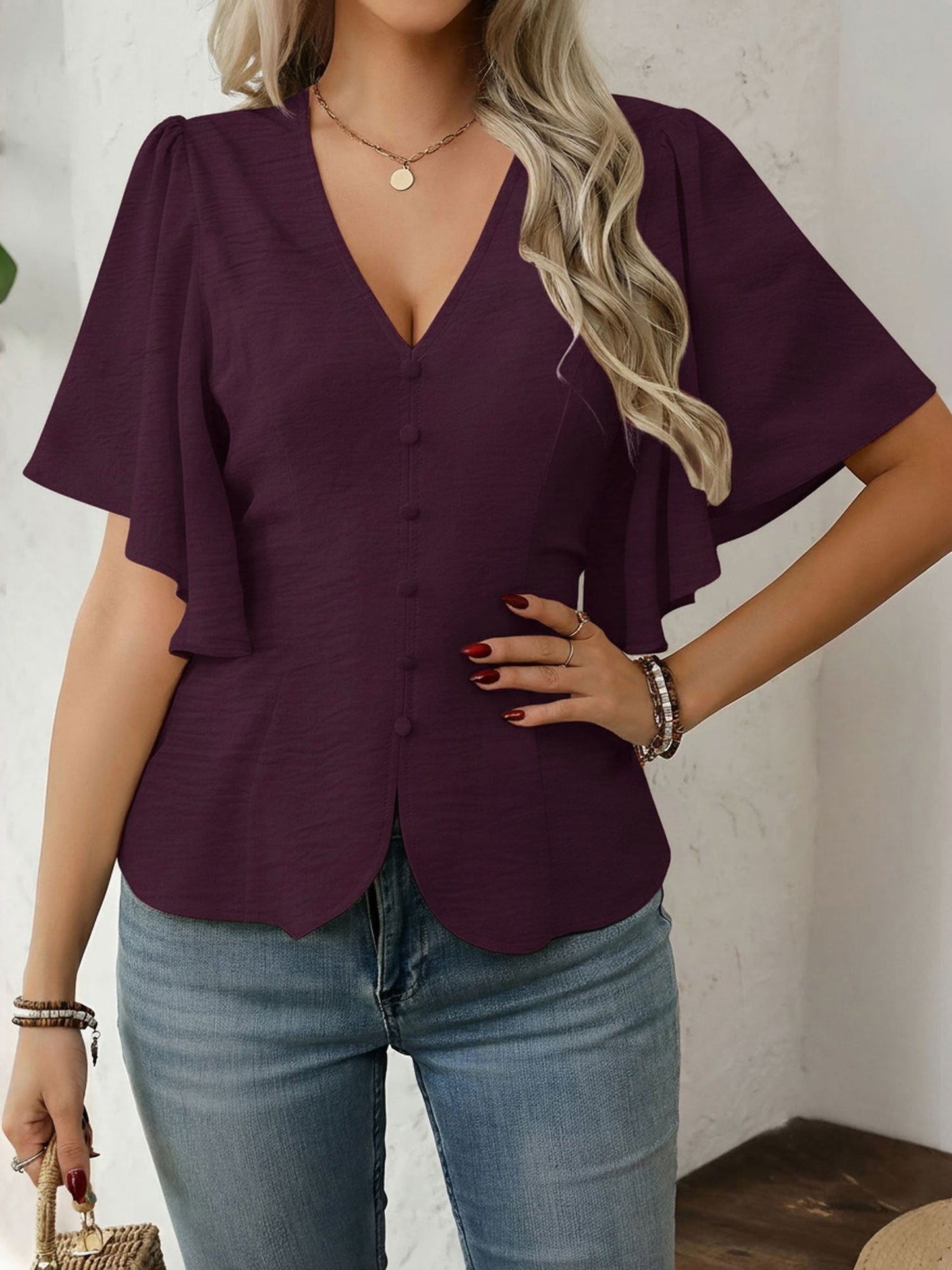Dark Red - Women's rust orange short flutter sleeve blouse featuring a V-neckline, fabric-covered button front, and a tailored peplum waist, styled with blue jeans.