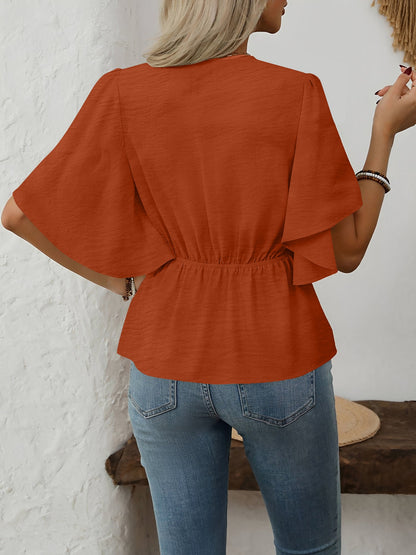 Brown - Women's rust orange short flutter sleeve blouse featuring a V-neckline, fabric-covered button front, and a tailored peplum waist, styled with blue jeans.