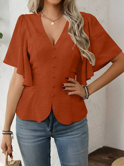 Brown - Women's rust orange short flutter sleeve blouse featuring a V-neckline, fabric-covered button front, and a tailored peplum waist, styled with blue jeans.