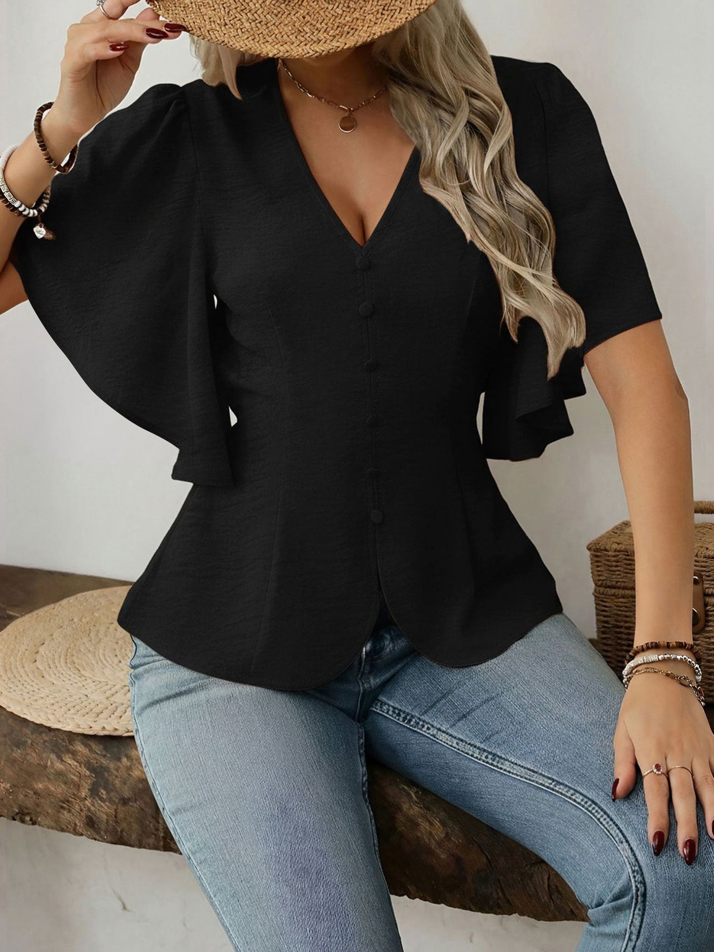 Black - Women's rust orange short flutter sleeve blouse featuring a V-neckline, fabric-covered button front, and a tailored peplum waist, styled with blue jeans.