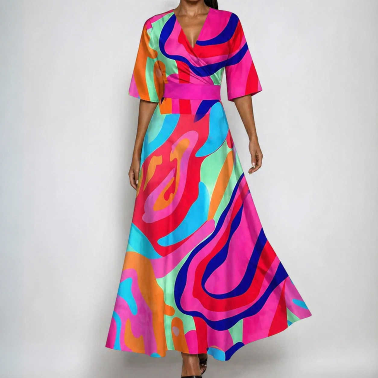 Fuschia - A woman wearing a cream-colored maxi dress featuring a watercolor floral print in blue, purple, and yellow, designed with a surplice V-neck, wide elbow-length sleeves, and a flowing skirt.