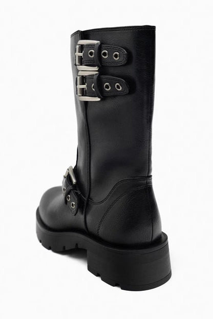 Black - A pair of women's dark brown faux leather mid-calf moto boots featuring three adjustable buckle straps and a chunky black lug sole.