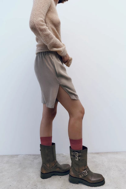 A pair of women's dark brown faux leather mid-calf moto boots featuring three adjustable buckle straps and a chunky black lug sole.
