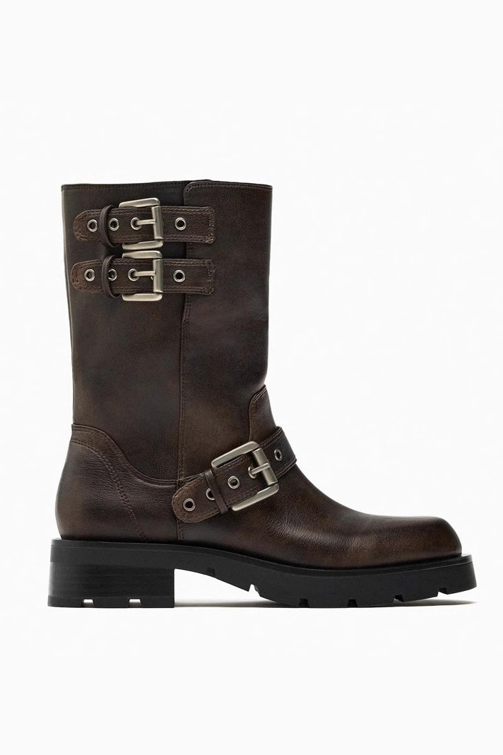 Brown - A pair of women's dark brown faux leather mid-calf moto boots featuring three adjustable buckle straps and a chunky black lug sole.