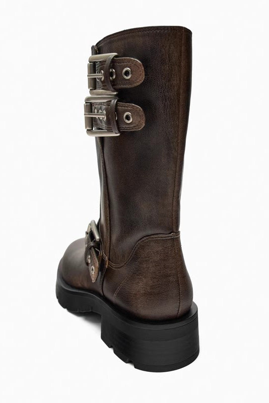 Brown - A pair of women's dark brown faux leather mid-calf moto boots featuring three adjustable buckle straps and a chunky black lug sole.