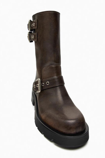 Brown - A pair of women's dark brown faux leather mid-calf moto boots featuring three adjustable buckle straps and a chunky black lug sole.