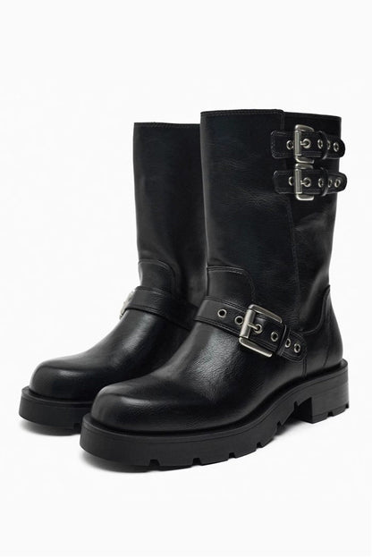 Brown - A pair of women's dark brown faux leather mid-calf moto boots featuring three adjustable buckle straps and a chunky black lug sole.