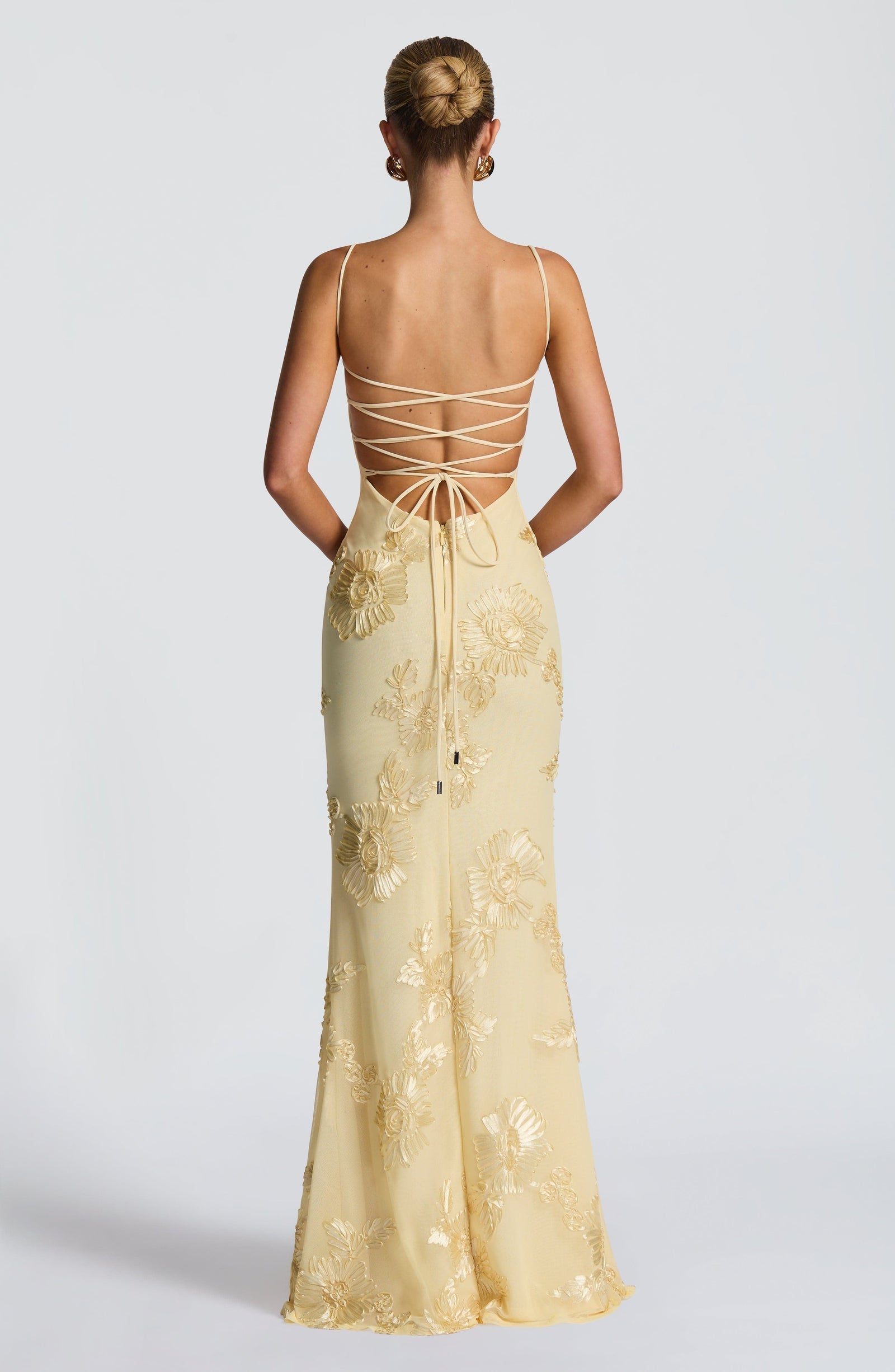 Light Blue - Women's pale yellow formal floor-length gown featuring a structured corset bodice, delicate spaghetti straps, and a sheer overlay embellished with intricate 3D floral appliques.
