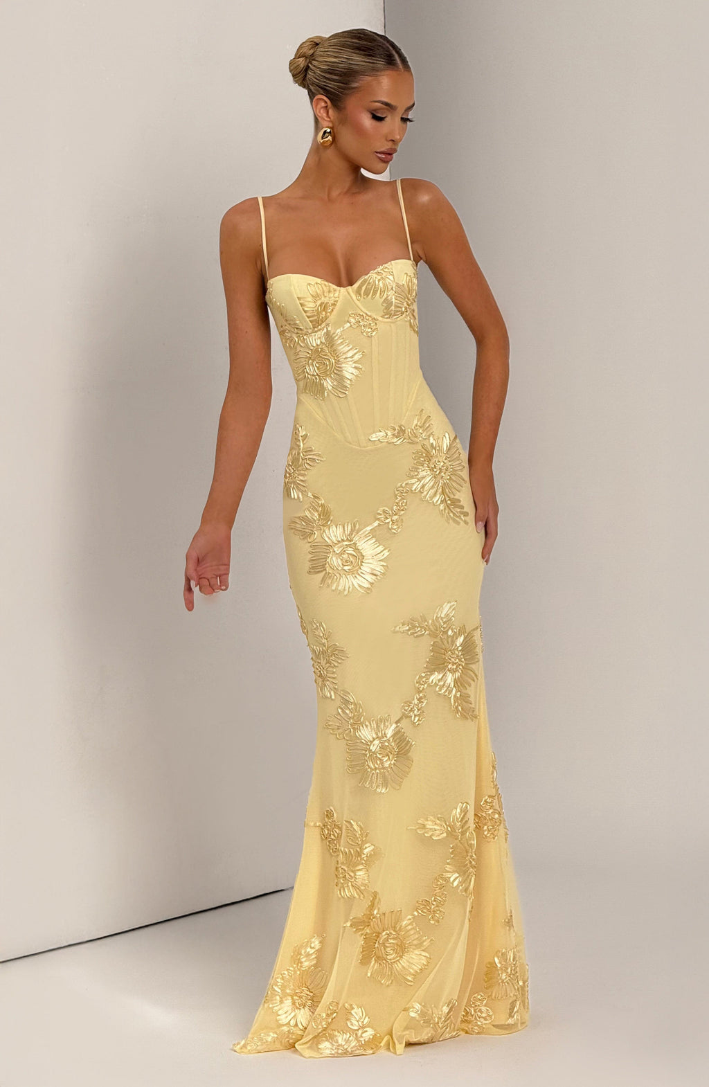 Light Blue - Women's pale yellow formal floor-length gown featuring a structured corset bodice, delicate spaghetti straps, and a sheer overlay embellished with intricate 3D floral appliques.