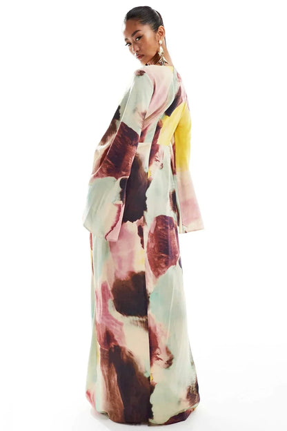 Watercolor - Women's formal floor-length maxi dress featuring a high neckline, wide flared long sleeves, a draped waist, and a large-scale abstract watercolor print in yellow, mint, pink, and deep brown.