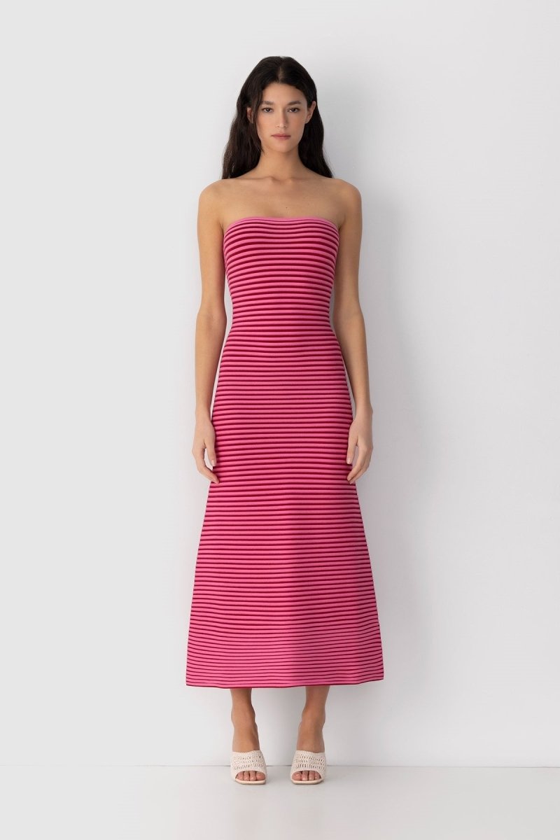 Hot Pink - A woman modeling a strapless knit maxi dress featuring a fitted column silhouette and an all-over horizontal stripe pattern.