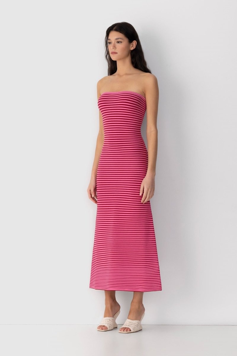 Hot Pink - A woman modeling a strapless knit maxi dress featuring a fitted column silhouette and an all-over horizontal stripe pattern.