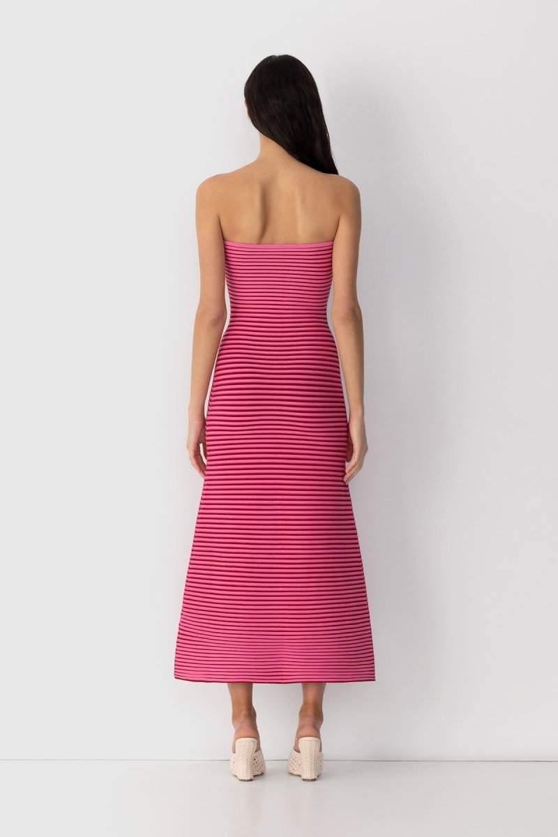 Hot Pink - A woman modeling a strapless knit maxi dress featuring a fitted column silhouette and an all-over horizontal stripe pattern.