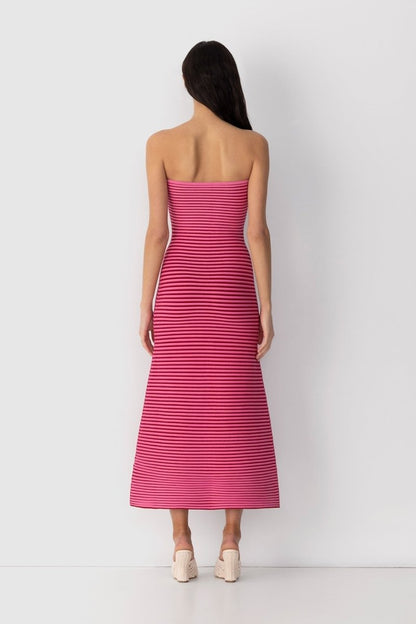 Hot Pink - A woman modeling a strapless knit maxi dress featuring a fitted column silhouette and an all-over horizontal stripe pattern.