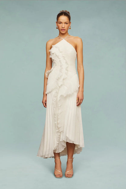 White - A woman wearing an elegant light purple midi dress featuring a halter neckline, all-over micro-pleating, and a dramatic asymmetrical cascading ruffle detail down the front.