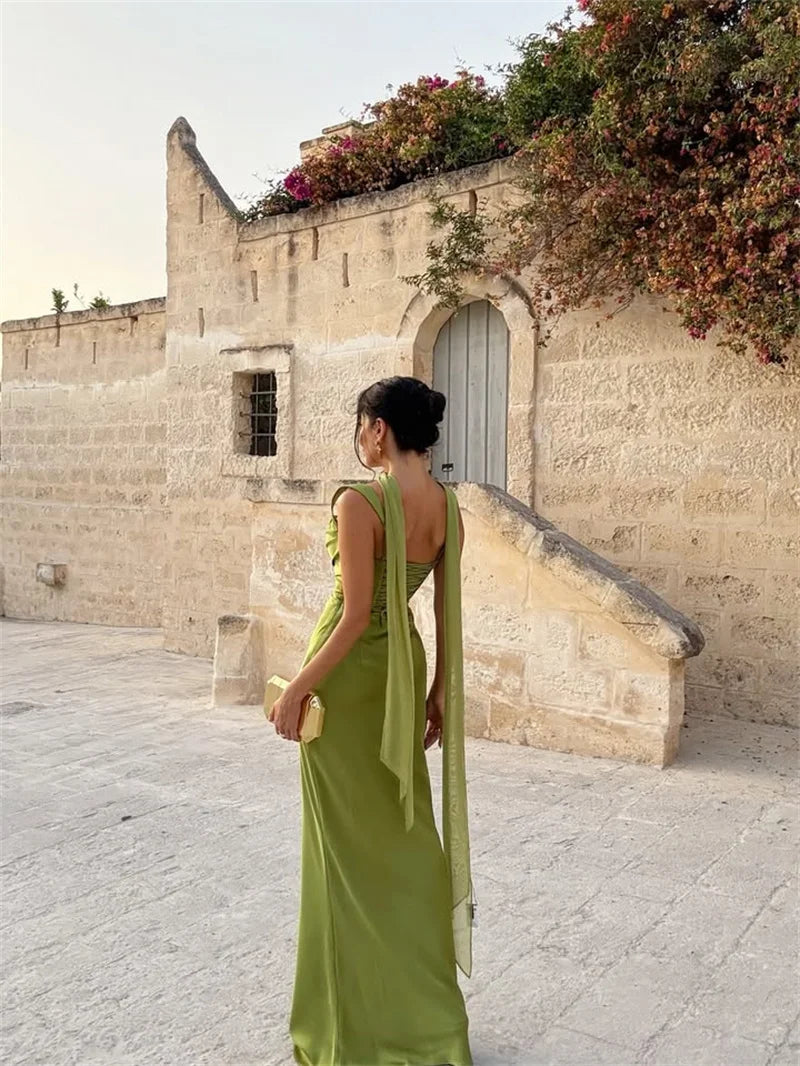 White - Women's elegant olive green satin slip dress featuring a cowl neckline, ruched bodice, wide straps, and a matching neck scarf detail, styled for a formal event.