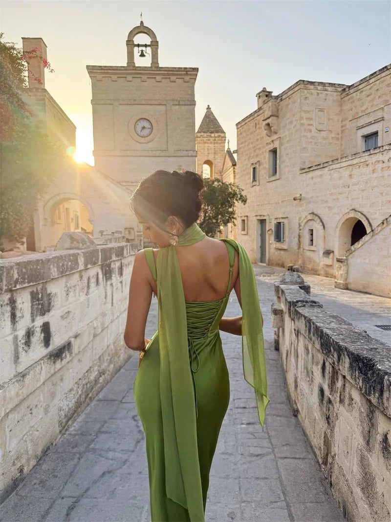 White - Women's elegant olive green satin slip dress featuring a cowl neckline, ruched bodice, wide straps, and a matching neck scarf detail, styled for a formal event.