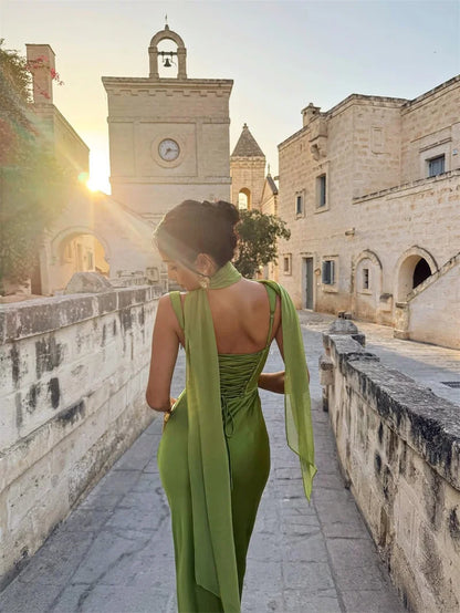 White - Women's elegant olive green satin slip dress featuring a cowl neckline, ruched bodice, wide straps, and a matching neck scarf detail, styled for a formal event.