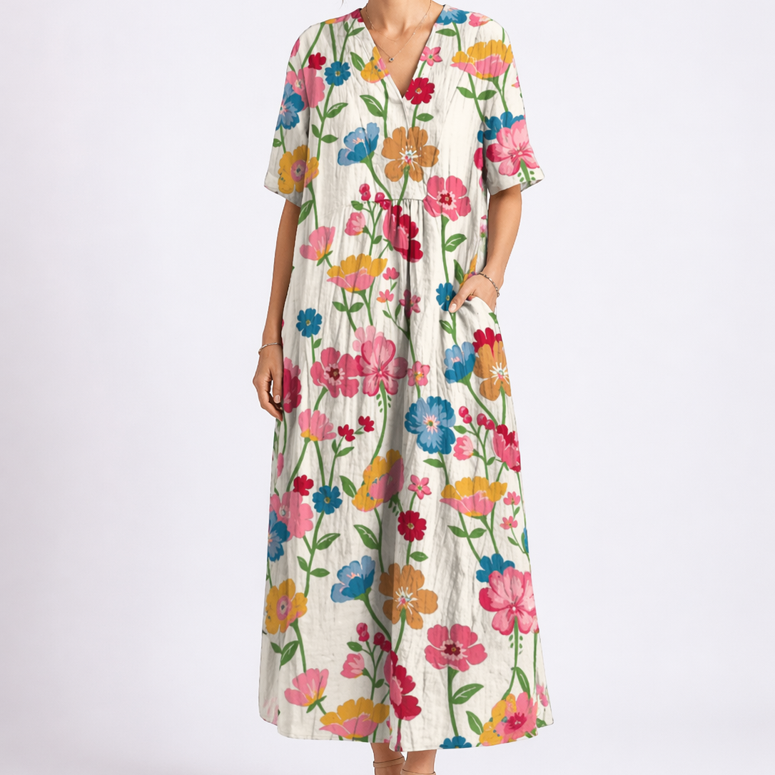 Multicolor - Model wearing a woven floral V-neck midaxi dress with short sleeves and side pockets against a plain grey background.