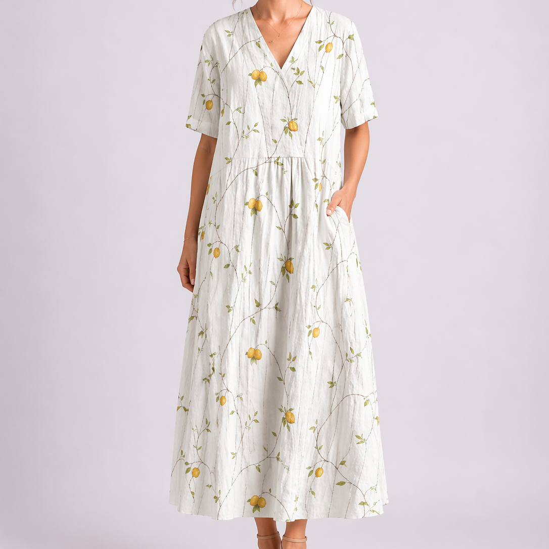 Yellow & White - Model wearing a woven floral V-neck midaxi dress with short sleeves and side pockets against a plain grey background.