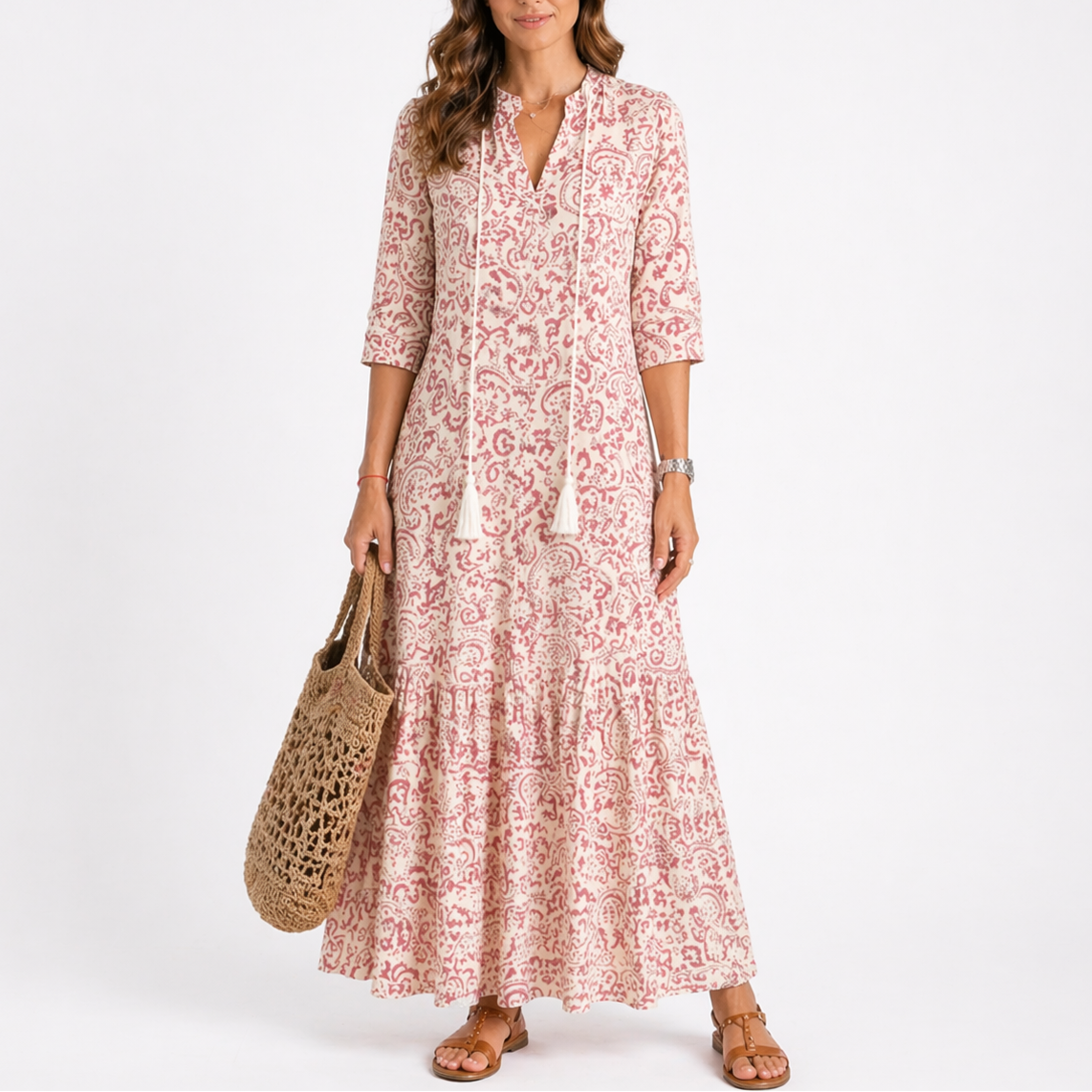 Red - Woman wearing a woven ikat pattern maxi dress with a V-neck, tassel ties, 3/4-sleeves, and a tiered hemline against a light grey background.