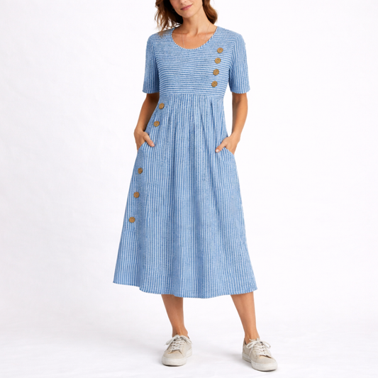 Blue - Model wearing a striped short-sleeve midi dress with asymmetric button detailing and side pockets against a plain background