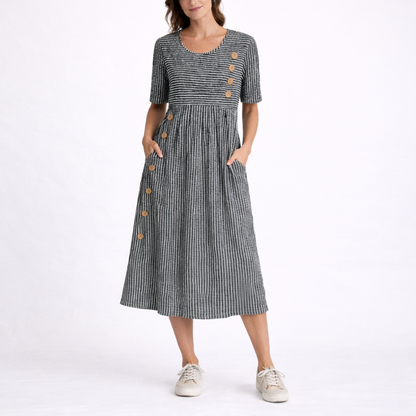 Gray - Model wearing a striped short-sleeve midi dress with asymmetric button detailing and side pockets against a plain background